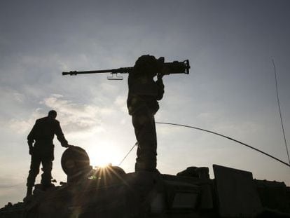 An Israeli soldier holds a weapon near the Gaza Strip.