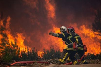 Firefighters battling a forest fire in Landiras, France on Monday, 
