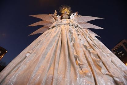 A woman dressed as a white dove, a symbol of peace, at the Three Kings parade in Madrid.