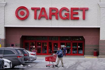 A shopper wheels his shopping cart through the parking lot after making a purchase at the Target store, Monday, Feb. 27, 2023, in Salem, N.H.