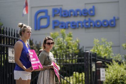 Kendal Underwood, left, and Brittany Nickens protest in support of abortion rights outside Planned Parenthood on Friday, June 24, 2022, in St.  Louis.
