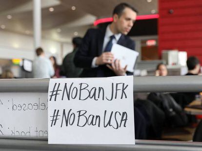 Signs against the travel ban at JFK airport in New York.