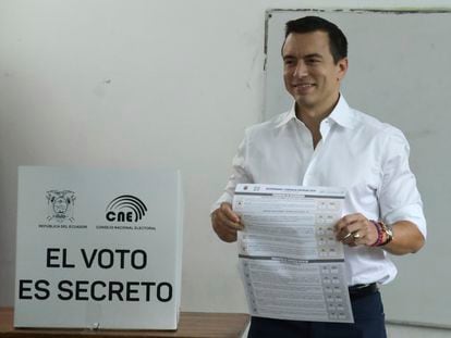 President Daniel Noboa holds the ballot during a referendum to endorse new security measures to crackdown on criminal gangs responsible for increasing violence, in Olon, Ecuador, Sunday, April 21, 2024.