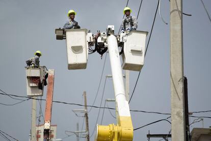 Puerto Rico Electric Power Authority workers repair distribution lines damaged by Hurricane Maria in the Cantera community of San Juan, Puerto Rico, Oct. 19, 2017.