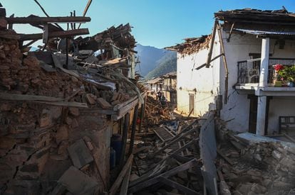 Residents walk amid the rubble of damaged homes in Jajarkot district on November 4, 2023, following an overnight a 5.6-magnitude earthquake.