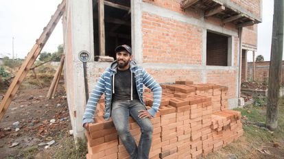 Daniel Escobedo oversees construction of a house funded by money sent from the US.