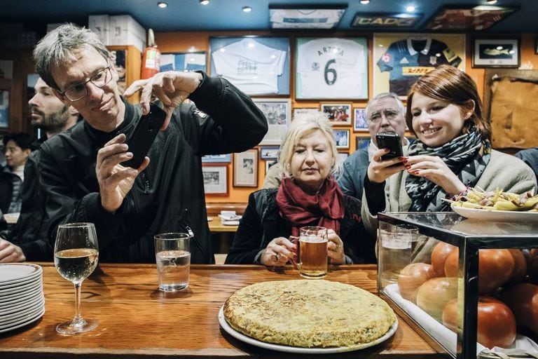 Diners photograph the famous Spanish omelette at Bar Nestor in San Sebastian.