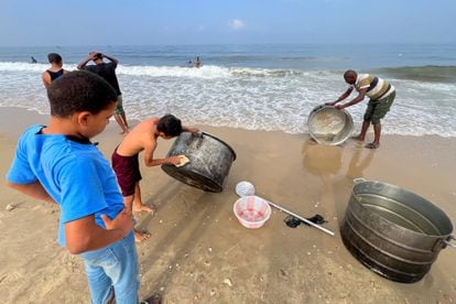 A group of Palestinians wash pots on a Gaza beach in the absence of drinking water, Nov. 2.