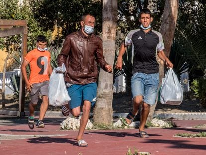Three Moroccan men in Ceuta flee from police on May 23.
