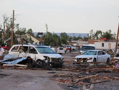 Debris and damaged vehicles cover a street after a tornado hit Perryton, Texas, on June 15, 2023.