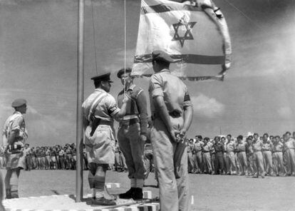 An Israeli soldier raises the national flag for the first time after the proclamation of the State of Israel, on May 14, 1948. 