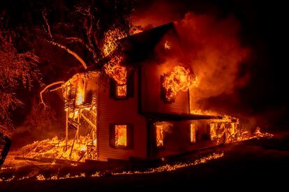 The Dixie Fire (2021) consumes a home in the town of Janesville, California.
