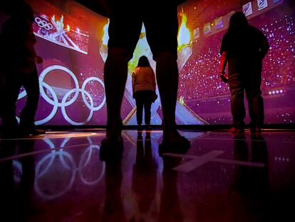 Visitors watch a simulation of the Parade of Nations exhibit during the opening day of the US Olympic and Paralympic Museum in Colorado Springs Colo., on July 30, 2020.