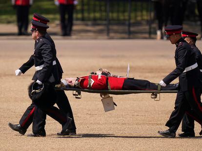 A trombone player of the military band is carried out on a stretcher after a faint during the Colonel's Review, the final rehearsal of the Trooping the Colour, the King's annual birthday parade, at Horse Guards Parade in London, Saturday, June 10, 2023.
