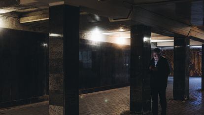 A man looks at his cellphone in an underground passageway on February 25 in Kyiv, Ukraine.