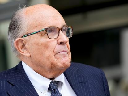 Rudy Giuliani speaks with reporters as he departs the federal courthouse, May 19, 2023, in Washington.