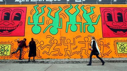 People walk by a recreation of an untitled mural painted by artist Keith Haring in New York.