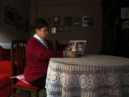 Benedicta García looks at photos of her daughter Pilar at home in Logroño.