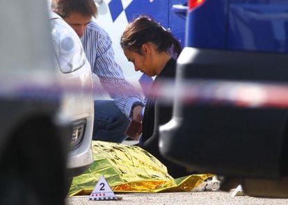 A woman weeps over the body of the man.
