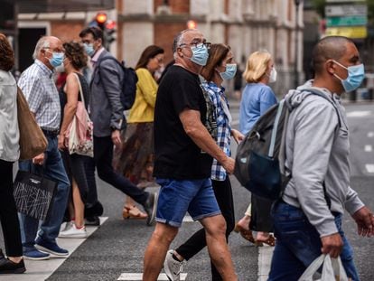 Pedestrians cross a street in Bilbao.