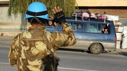 A Unifil soldier waves to a school bus in the south of Lebanon in December.