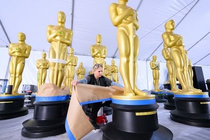 A worker prepares several Oscar statues for the gala on Wednesday, March 8. 
