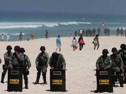 Police form a blockade on Monday during the bid-awarding ceremony at a nearby hotel on Barra de Tijuca beach in Rio de Janeiro.