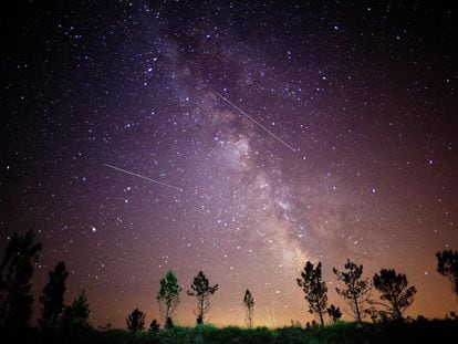 A view of the night sky with the Milky Way and several meteors known as Perseids.