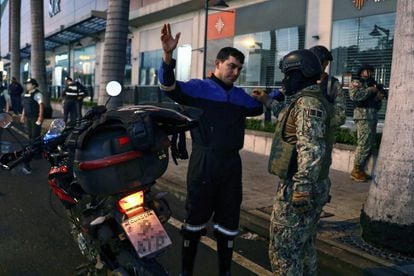 A member of the army checks a man in Guayaquil, Ecuador, after a state of emergency was declared on April 3.