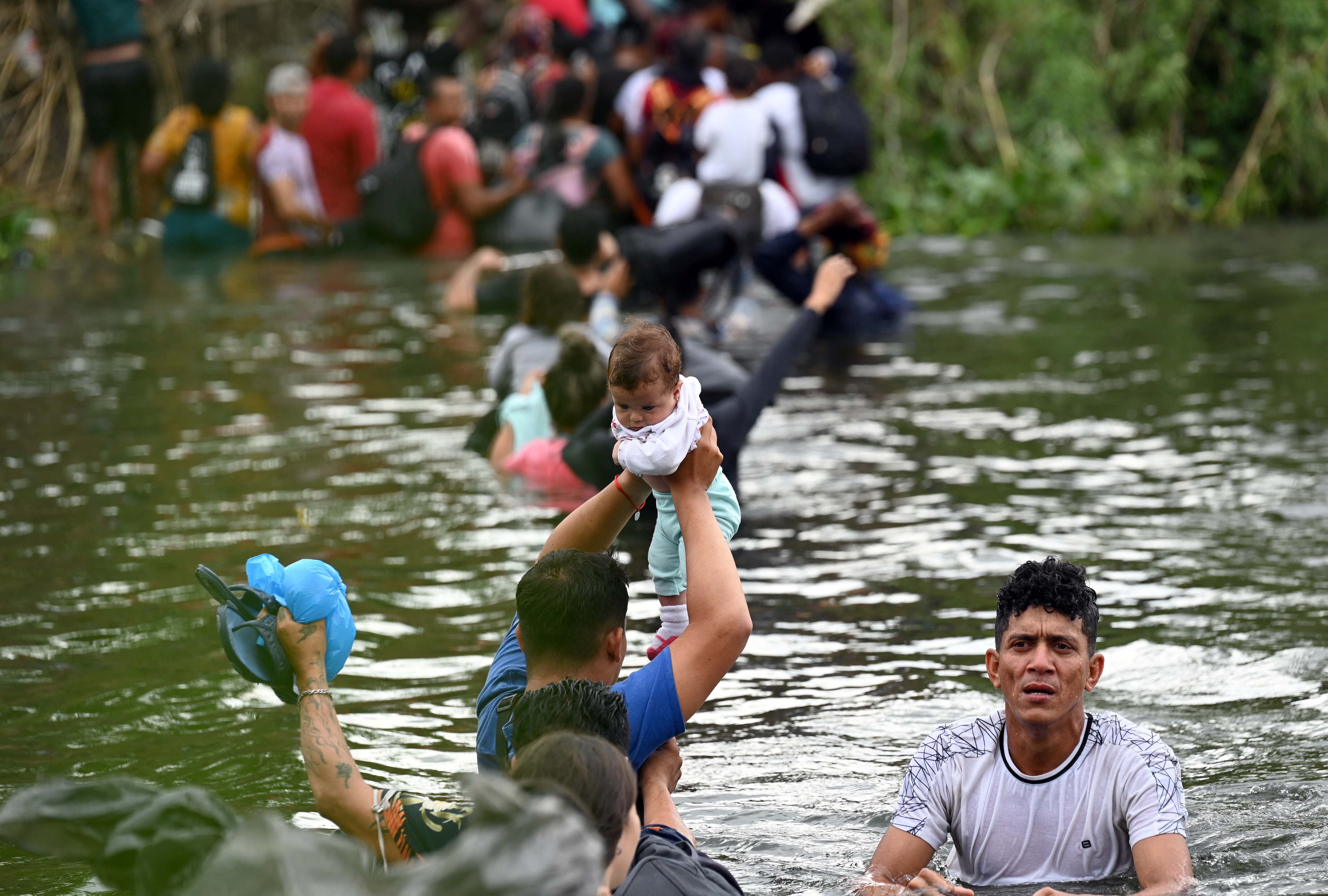 A group of migrants cross the Río Bravo.