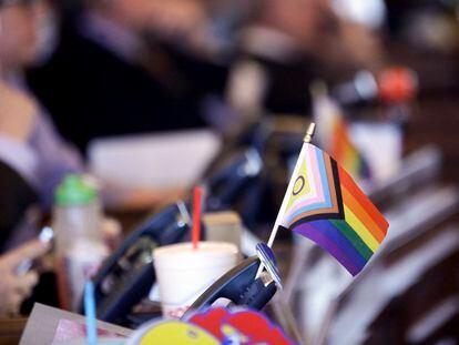 FILE - A flag supporting LGBTQ+ rights decorates a desk on the Democratic side of the Kansas House of Representatives during a debate, March 28, 2023