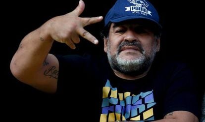 Maradona signals to photographers at the stadium during 'La Bombonera' match in Argentina.