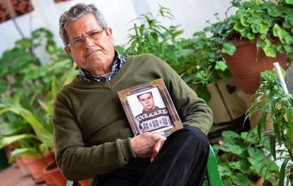 Guillem Agull&oacute; Sr holds a photograph of his son.