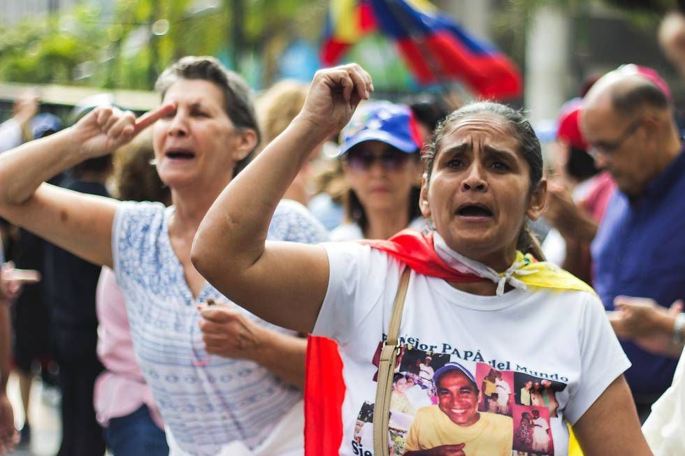 People protest during a demonstration against the blackout and the Nicolás Maduro government.