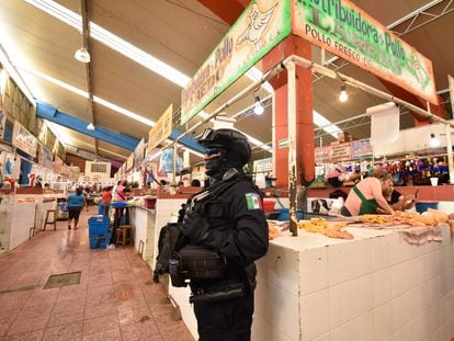 A police officer guards chicken stalls in Chilpancingo (Guerrero), after the murder of eight merchants in June 2022.