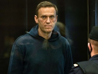 In this file photo taken on February 2, 2021 Russian opposition leader Alexei Navalny, charged with violating the terms of a 2014 suspended sentence for embezzlement, stands inside a glass cell during a court hearing in Moscow.