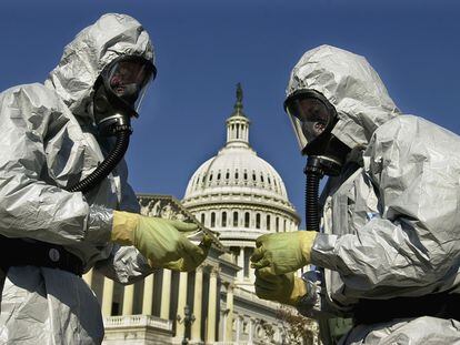 With the U.S. Capitol in the background, members of an U.S. Marine Corps' Chemical-Biological Incident Response Force demonstrate anthrax clean-up techniques during a news conference in Washington in this Oct. 30, 2001 file photo