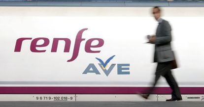 A passenger walks to board a high-speed AVE train.