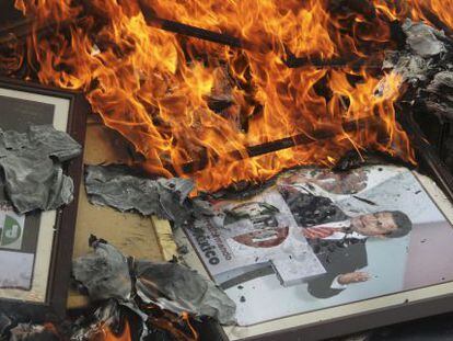 Members of the CNTE teachers’ union burn a photograph of Peña Nieto during a protest.