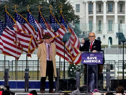 Chapman University law professor John Eastman stands at left as former New York Mayor Rudolph Giuliani speaks in Washington at a rally in support of President Donald Trump, called the "Save America Rally" on Jan. 6, 2021