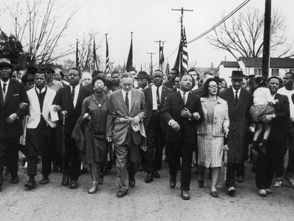 American civil rights campaigner Martin Luther King and his wife Coretta Scott King lead a black voting rights march from Selma, Alabama, to the state capital in Montgomery, in 1965.