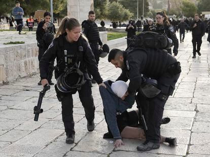 Israeli police arrest a Palestinian woman at the Al-Aqsa Mosque compound following a raid at the site in the Old City of Jerusalem during the Muslim holy month of Ramadan, Wednesday, April 5, 2023.