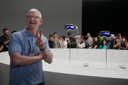 Apple CEO Tim Cook poses for photos in front of the company's new Apple Vision Pro