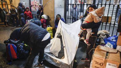 Asylum seekers lining up outside a social services building in Madrid.