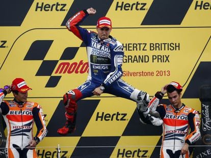 Yamaha MotoGP rider Jorge Lorenzo celebrates winning the British Grand Prix with Honda riders Marc Marquez (l) and Dani Pedrosa also on the podium.