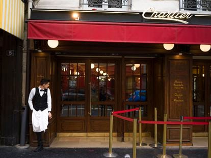 A waiter smokes a cigarette during a break at the Bouillon Chartier in Paris