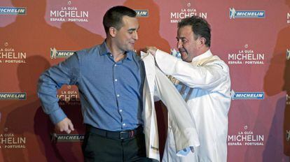 Martín Berasategui helps put a white jacket on his head chef at Lasarte, Paolo Casagrande from Italy, after receiving their third Michelin star in Girona on Wednesday.