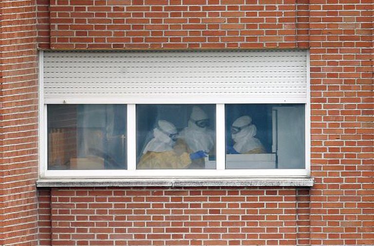 Health workers at Carlos III hospital wearing protective suits.