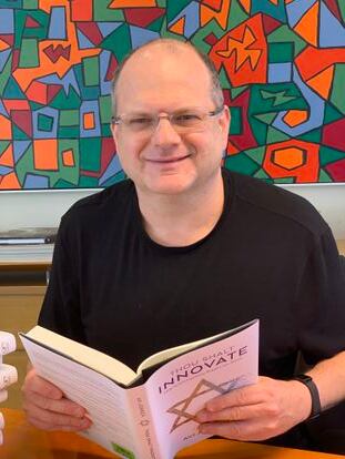 Gil Shwed with a copy of the book ‘Thou Shalt Innovate.’