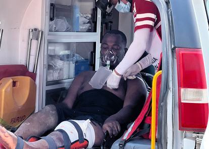 Paramedics treat Eric Williams, who suffered a gunshot wound to the leg, on March 7.